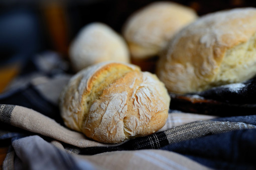 Fresh rolls beautifully arranged on a clean tea towel