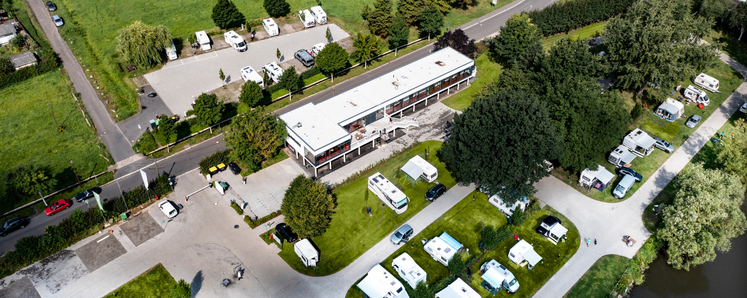 Aerial view of the Kassel campsite directly on the Fulda river with adjacent motorhome parking area
