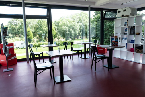 Interior view of the bistro at the campsite in Kassel with seating and refrigerators