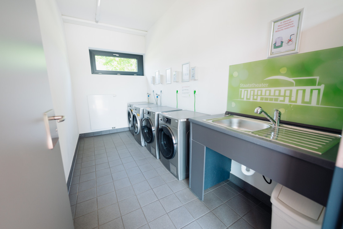 In the laundry room there are washing machines and a sink for hand washing