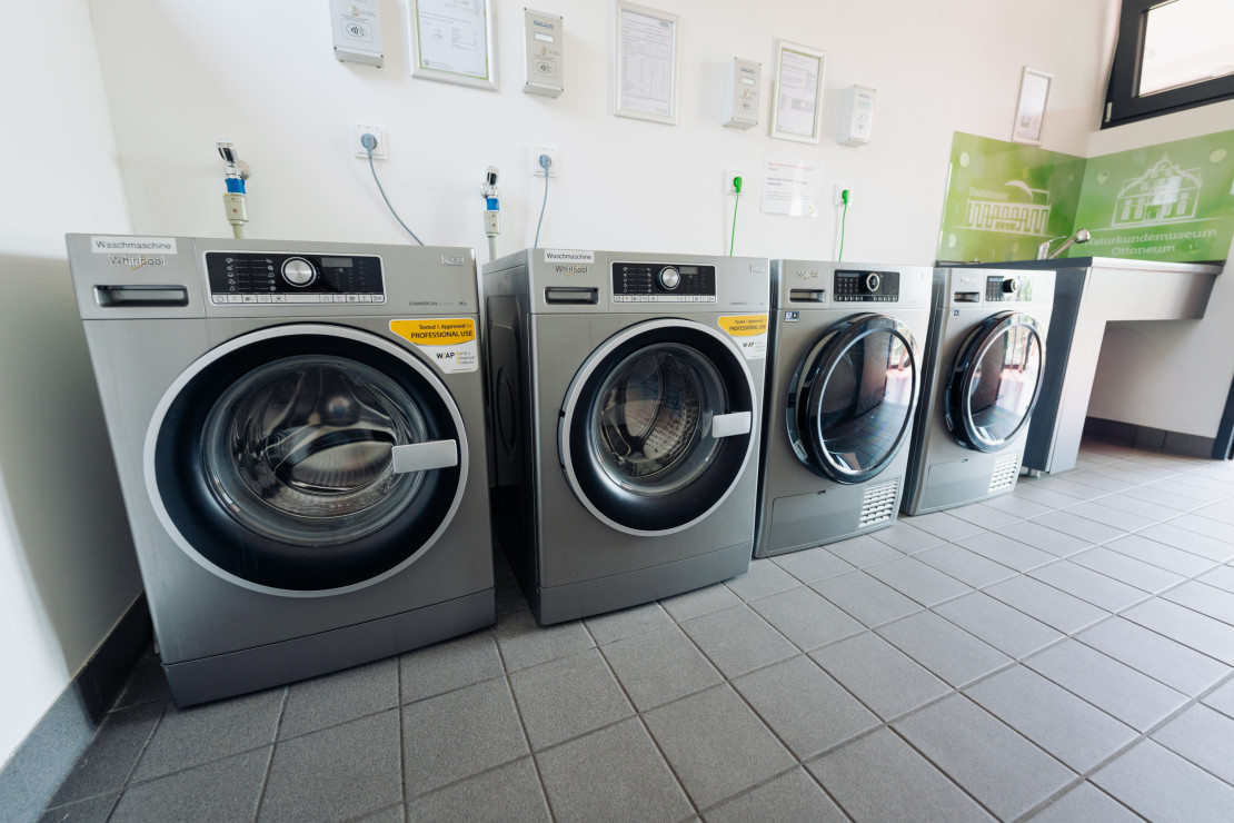 View of modern washing machines and dryers in the functional building of the Kassel campsite